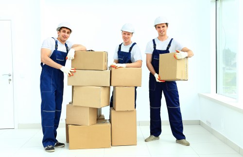 Professional movers carrying boxes from a Dulwich property