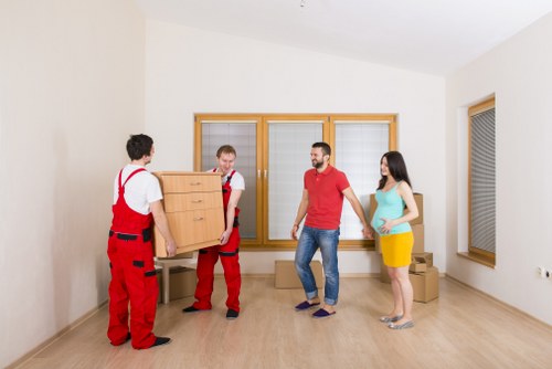 Professional movers loading items into a removals van